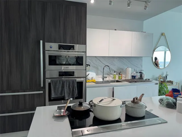 a kitchen with a sink and a stove top oven