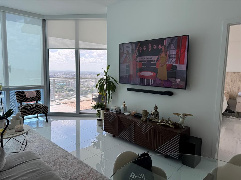 851 Northeast 1st Avenue, Unit 2606 Miami, FL 33132 - Photo 9 of 30 a living room with furniture and a large window