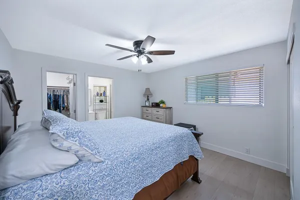 a bedroom with a large bed and a chandelier