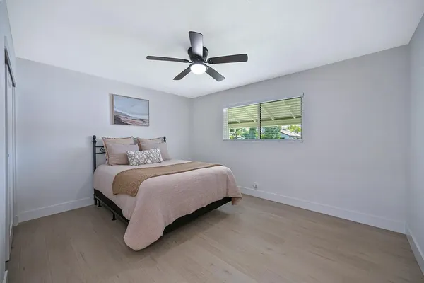 a bedroom with a bed and a window