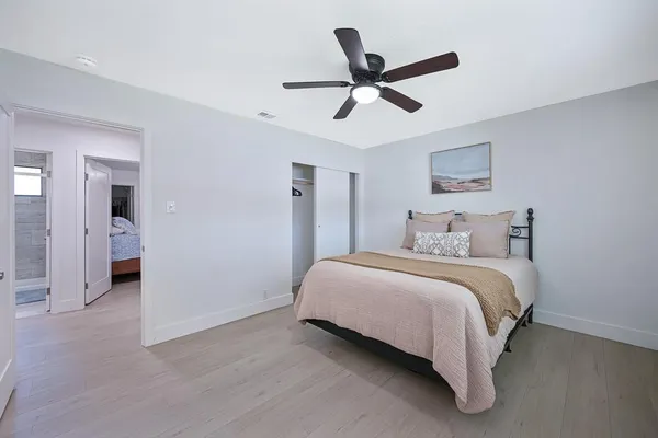 a bedroom with a bed and a painting