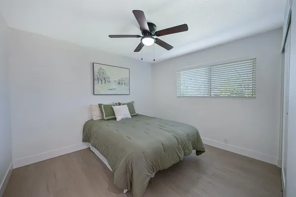 a bedroom with a bed and window