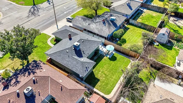 an aerial view of a house with a garden and swimming pool
