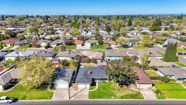 an aerial view of residential houses with outdoor space