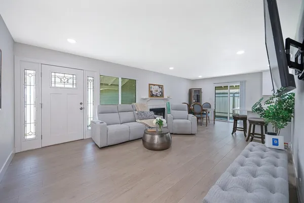 a living room with fireplace furniture and a flat screen tv
