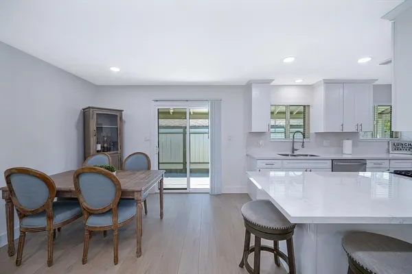a kitchen with granite countertop cabinets a dining table and chairs