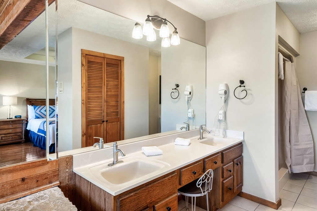 2044 Hickory Ridge Way, Unit 334 Sevierville, TN 37862 - Photo 21 of 28 a bathroom with a sink double vanity and a mirror