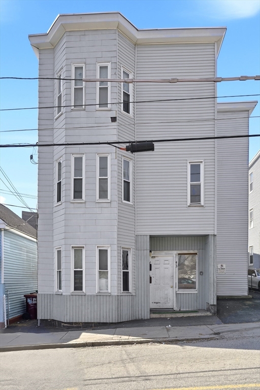a front view of a house with a wooden fence