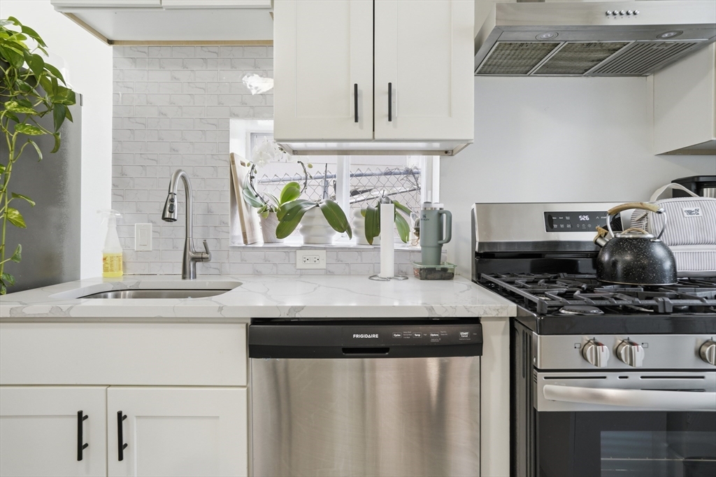 43 Wamesit Street Lowell, MA 01852 - Photo 16 of 34 a kitchen with stainless steel appliances a sink and a stove