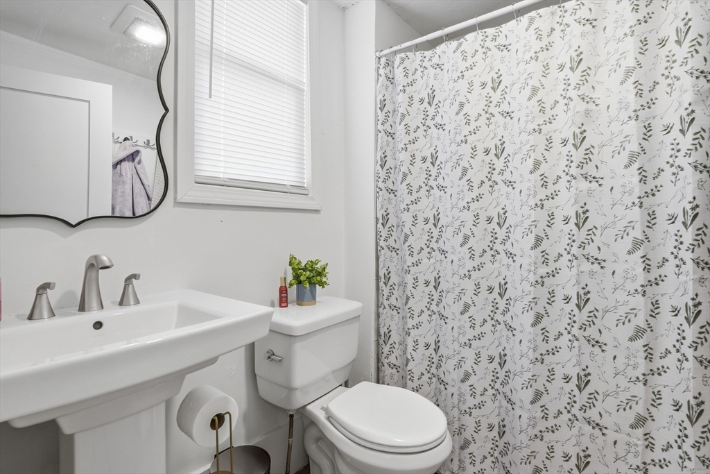 43 Wamesit Street Lowell, MA 01852 - Photo 18 of 34 a bathroom with a sink a toilet and a mirror