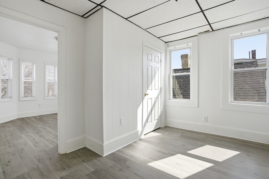 43 Wamesit Street Lowell, MA 01852 - Photo 19 of 34 a view of a big room with wooden floor and windows