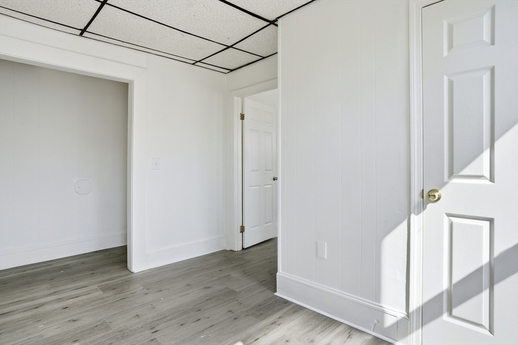 43 Wamesit Street Lowell, MA 01852 - Photo 20 of 34 a view of a hallway with wooden floor and staircase
