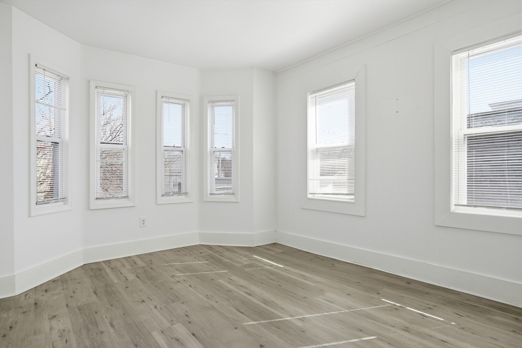 43 Wamesit Street Lowell, MA 01852 - Photo 21 of 34 a view of empty room with wooden floor and fan