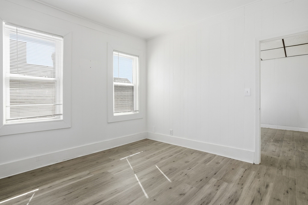 43 Wamesit Street Lowell, MA 01852 - Photo 23 of 34 a view of an empty room with wooden floor and a window