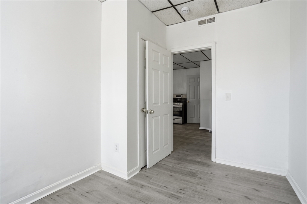 43 Wamesit Street Lowell, MA 01852 - Photo 25 of 34 a view of a hallway with wooden floor