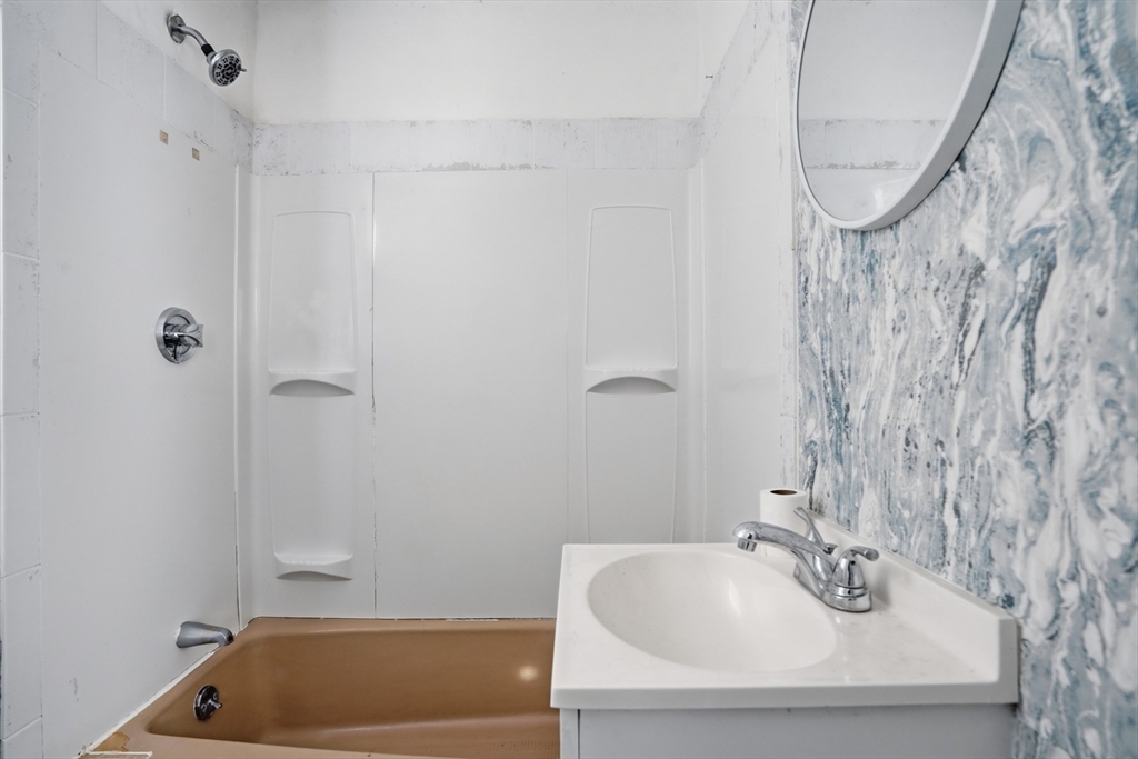 43 Wamesit Street Lowell, MA 01852 - Photo 26 of 34 a bathroom with a tub and sink