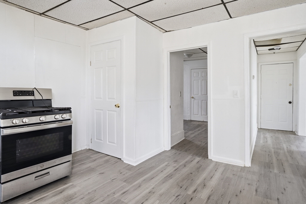 43 Wamesit Street Lowell, MA 01852 - Photo 28 of 34 a view of a kitchen with wooden floor and a fireplace