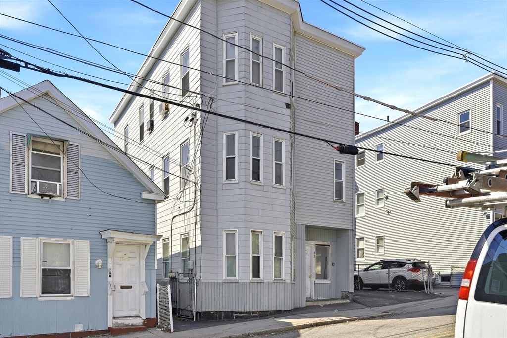 43 Wamesit Street Lowell, MA 01852 - Photo 3 of 34 a view of a building with car parked on the road