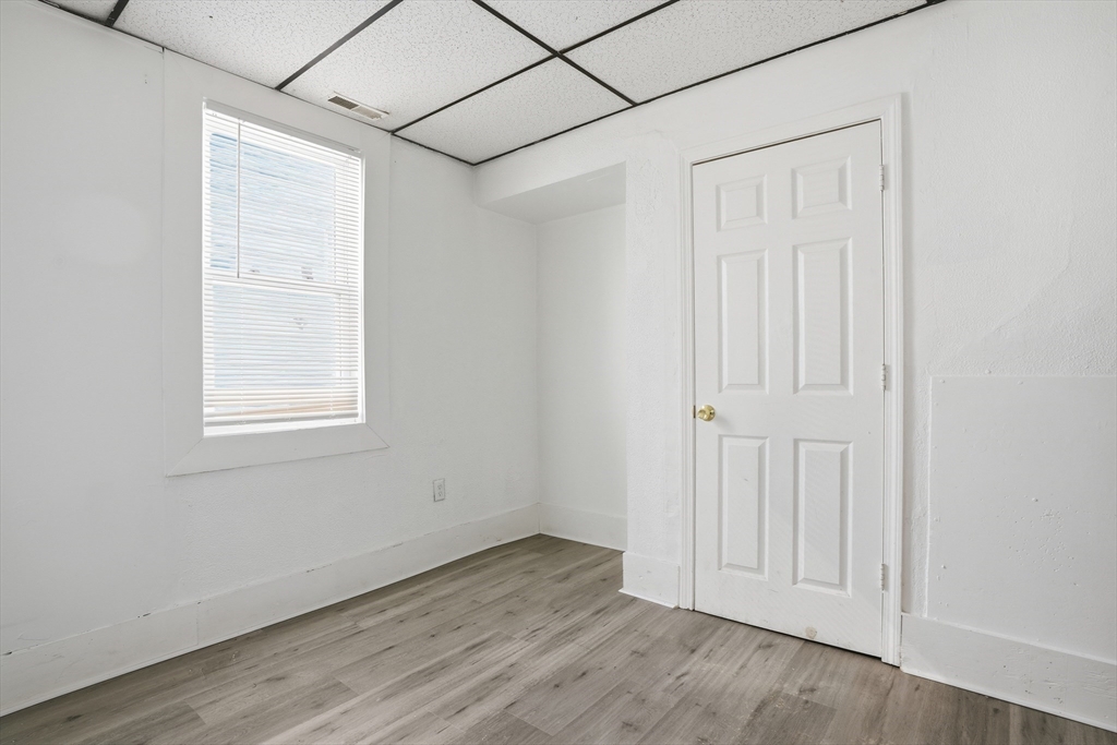 43 Wamesit Street Lowell, MA 01852 - Photo 31 of 34 an empty room with wooden floor and windows