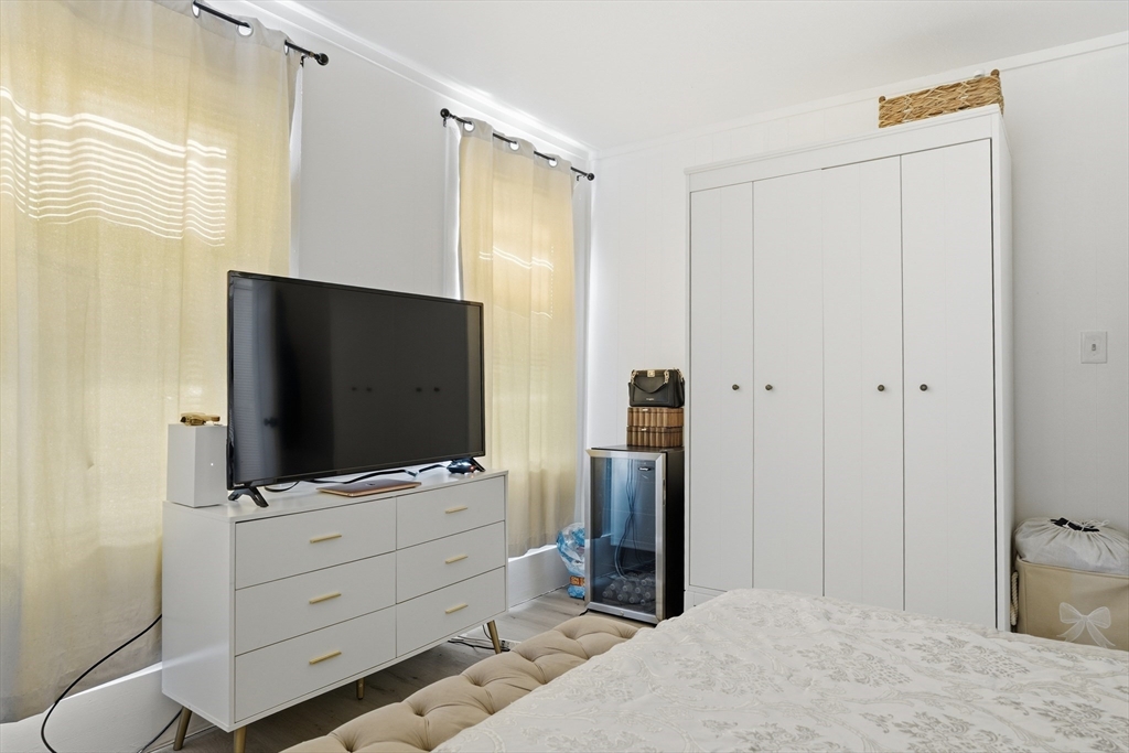 43 Wamesit Street Lowell, MA 01852 - Photo 6 of 34 a room with cabinet and flat screen tv