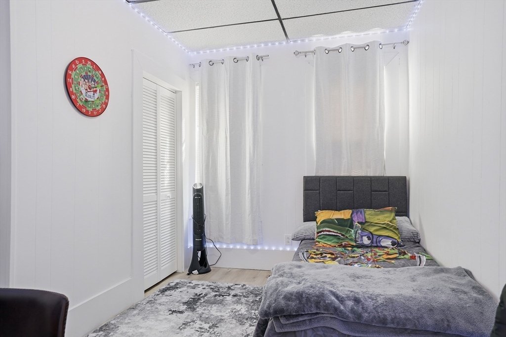 43 Wamesit Street Lowell, MA 01852 - Photo 8 of 34 a bedroom with a bed and a table in it