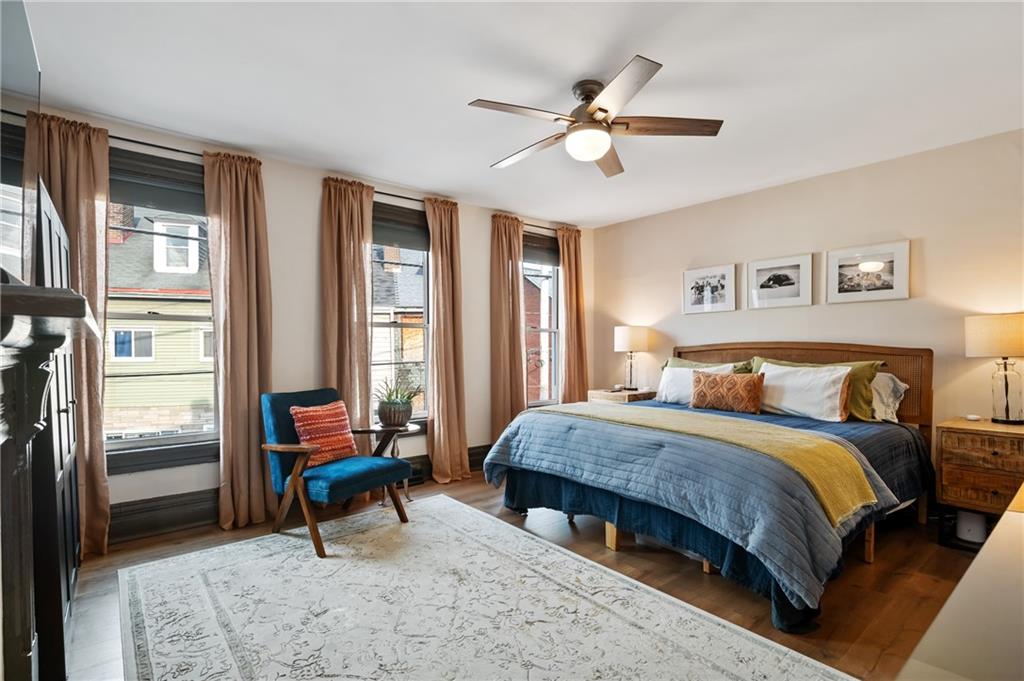 255 Edmond Street Pittsburgh, PA 15224 - Photo 23 of 50 a bedroom with a bed and a chandelier
