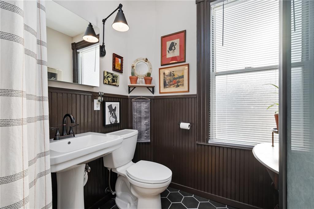 255 Edmond Street Pittsburgh, PA 15224 - Photo 31 of 50 a bathroom with a sink a toilet and a window