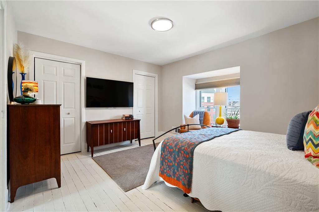 255 Edmond Street Pittsburgh, PA 15224 - Photo 36 of 50 a bedroom with a bed and a flat screen tv