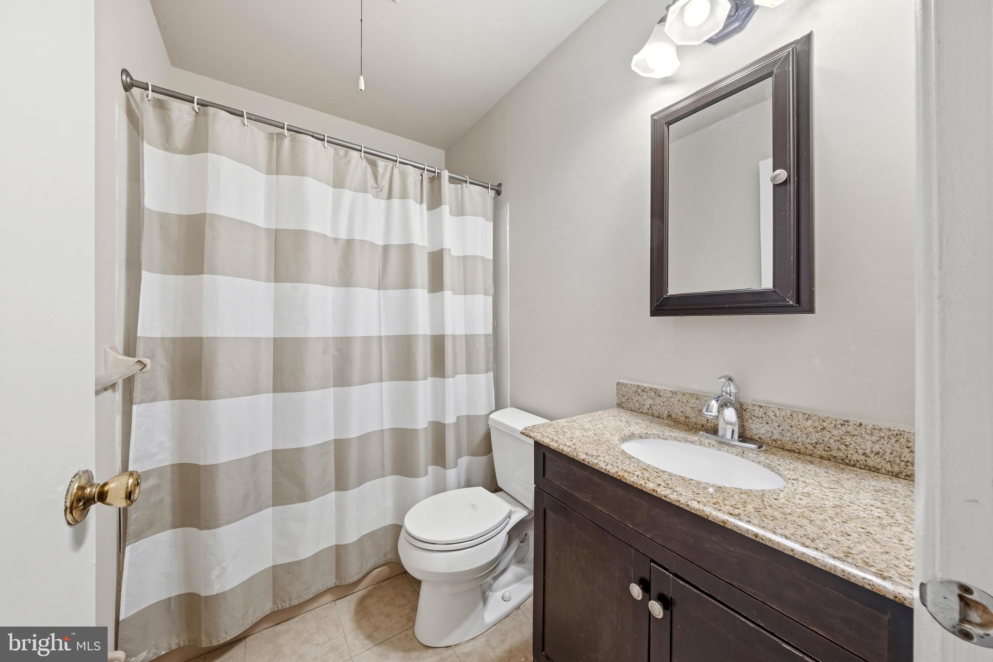 202 Shady Lane Marlton, NJ 08053 - Photo 27 of 38 a bathroom with a granite countertop sink a toilet and a mirror