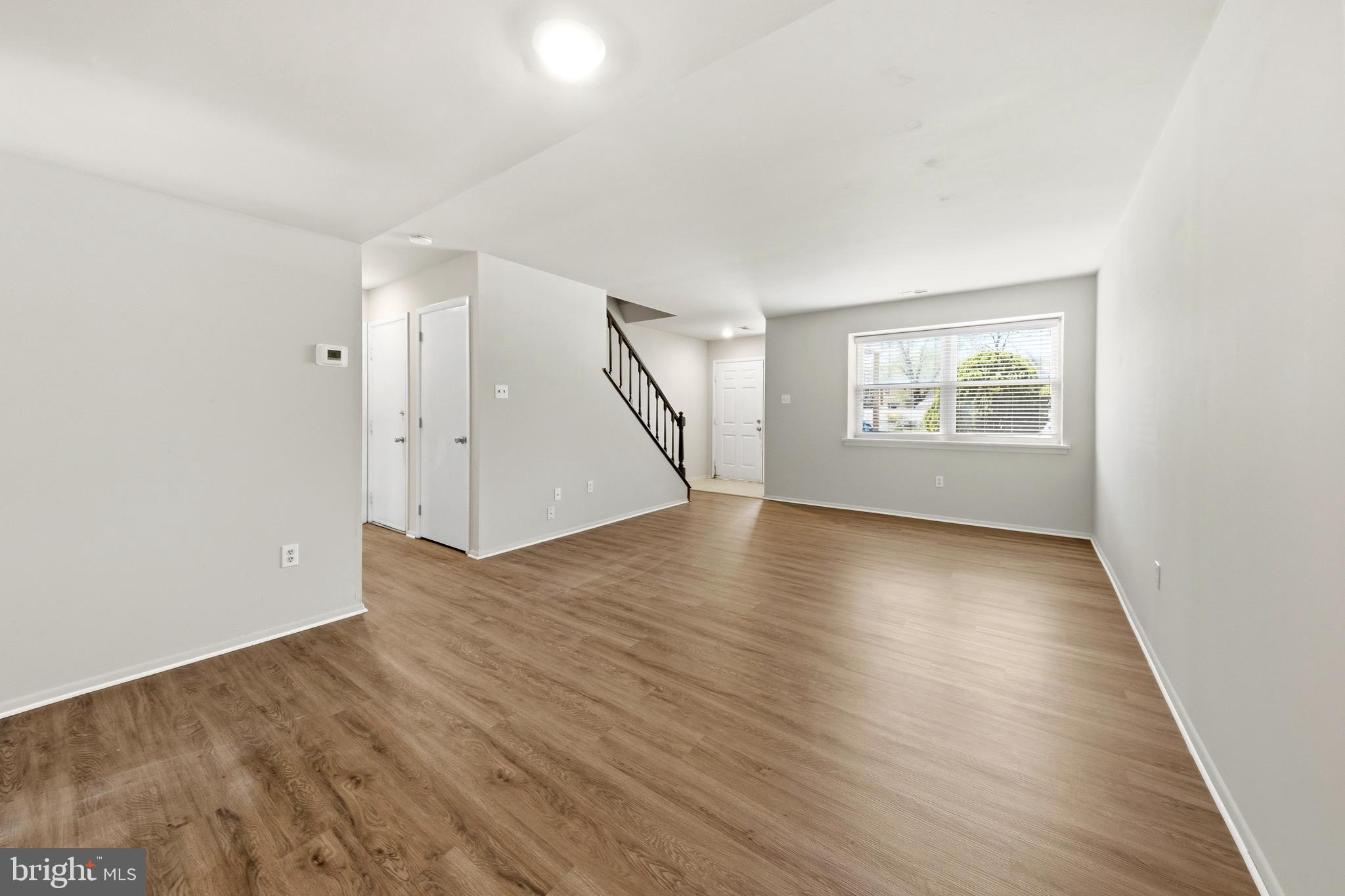 202 Shady Lane Marlton, NJ 08053 - Photo 4 of 38 an empty room with wooden floor and windows
