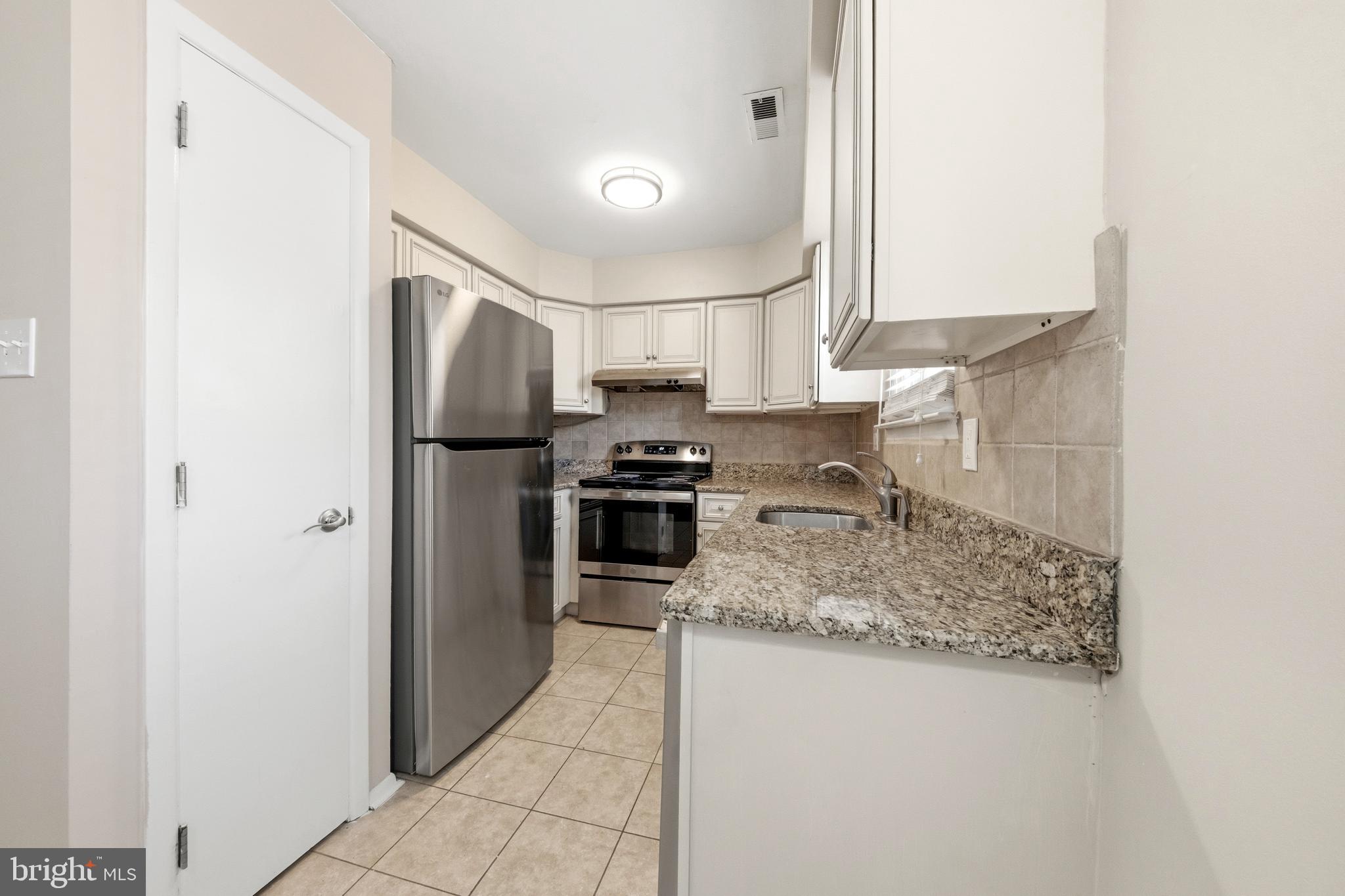 202 Shady Lane Marlton, NJ 08053 - Photo 5 of 38 a kitchen with stainless steel appliances granite countertop a sink stove and refrigerator