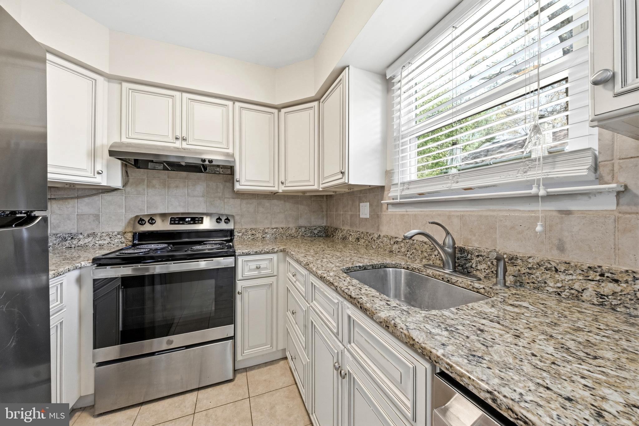 202 Shady Lane Marlton, NJ 08053 - Photo 8 of 38 a kitchen with granite countertop a sink stove and cabinets