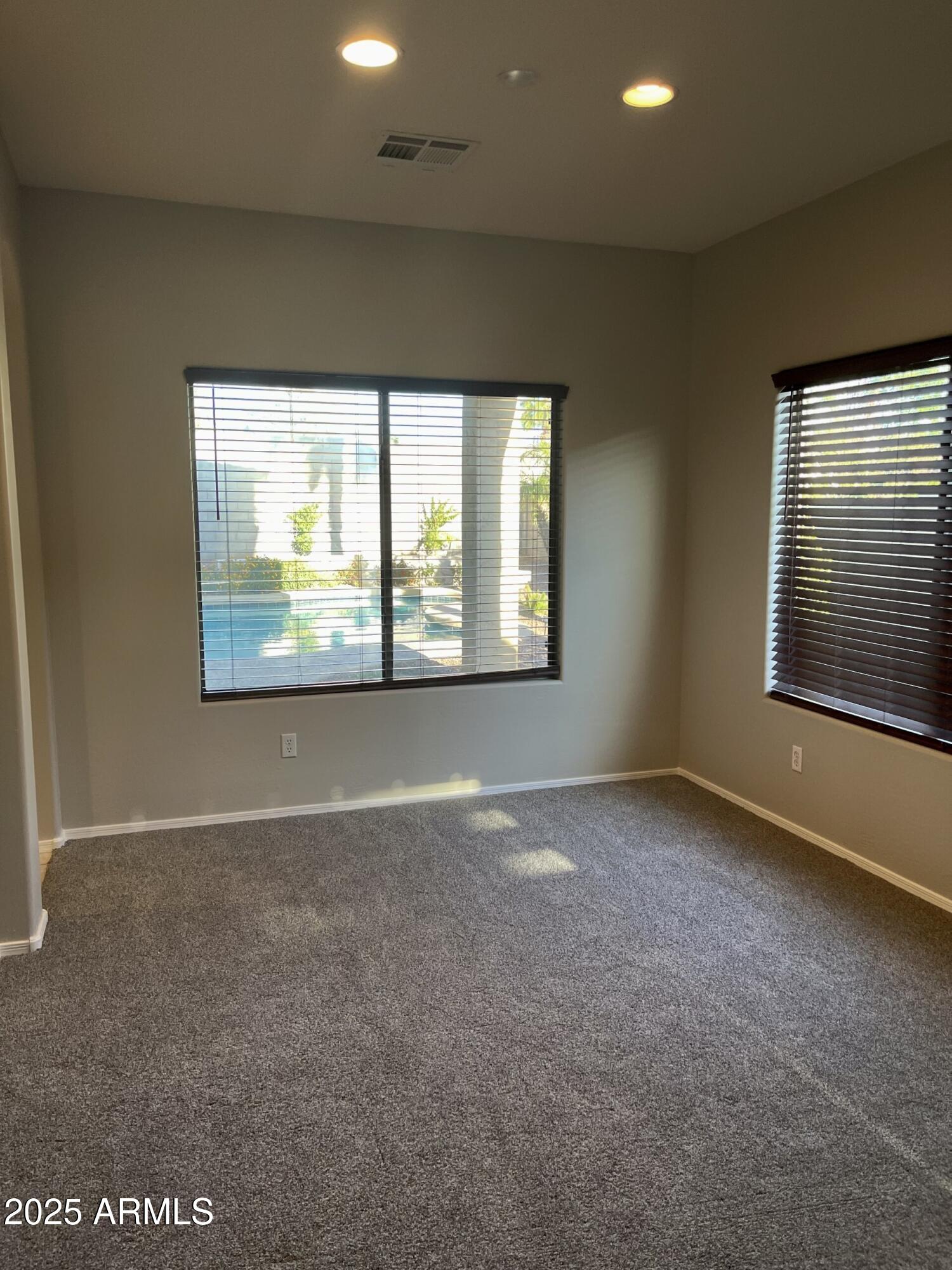 3613 North 127th Drive Avondale, AZ 85392 - Photo 5 of 12 an empty room with windows