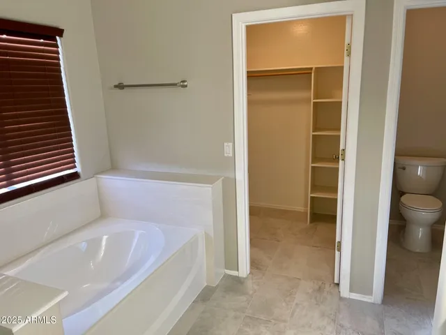 a bathroom with a bathtub and toilet