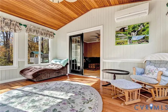 a view of a livingroom with furniture window and wooden floor