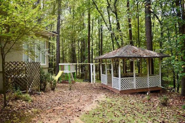a view of a wooden deck with a yard