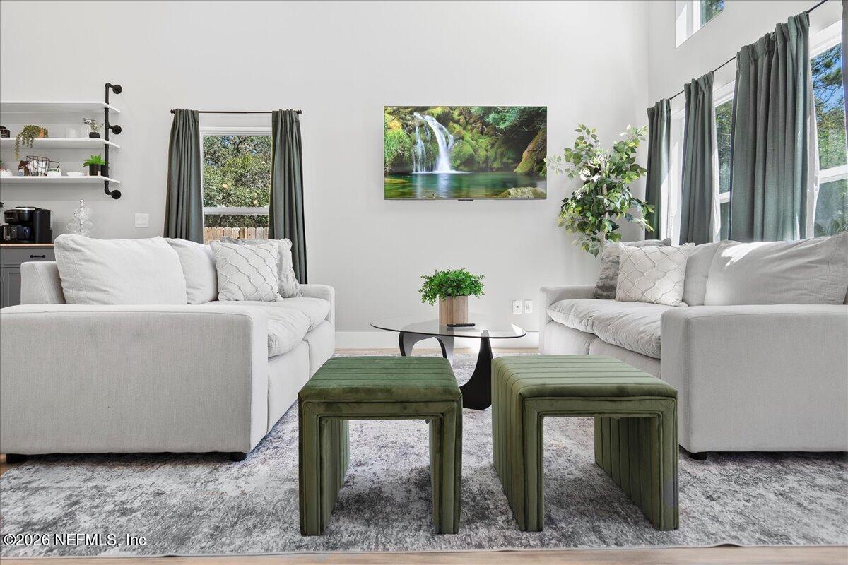 800 9th Street St. Augustine, FL 32084 - Photo 12 of 45 a living room with furniture and a large window