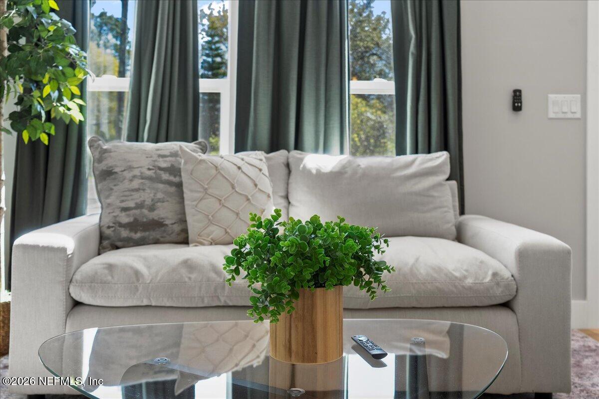 800 9th Street St. Augustine, FL 32084 - Photo 14 of 45 a living room with furniture and a potted plant