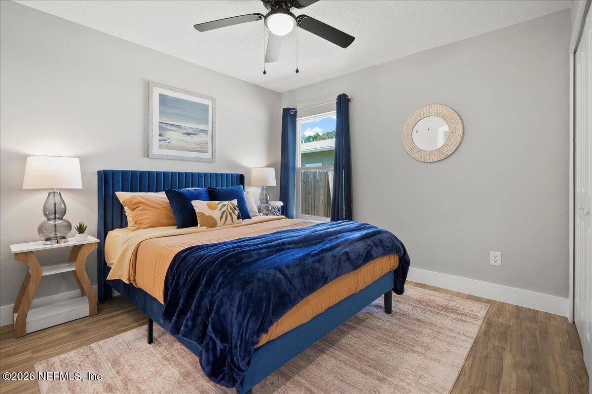 800 9th Street St. Augustine, FL 32084 - Photo 17 of 45 a bedroom with a bed and a chandelier