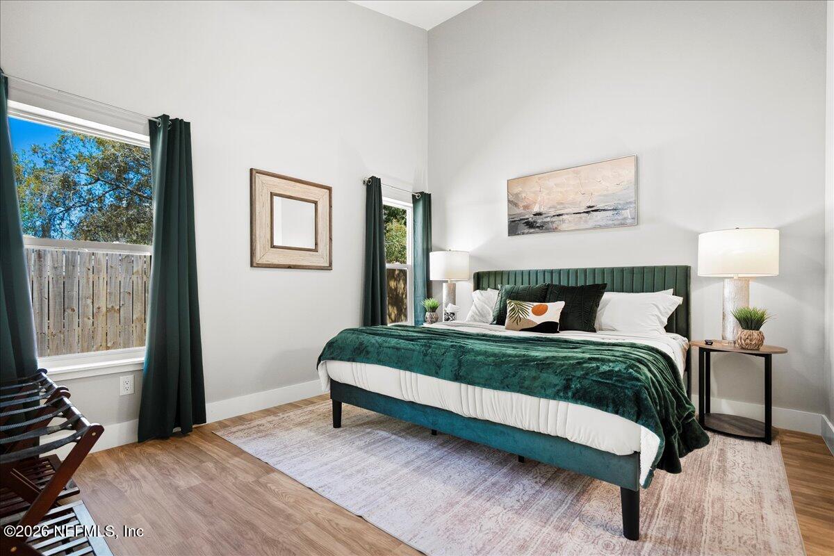 800 9th Street St. Augustine, FL 32084 - Photo 20 of 45 a bedroom with a bed painting on wall and a large window