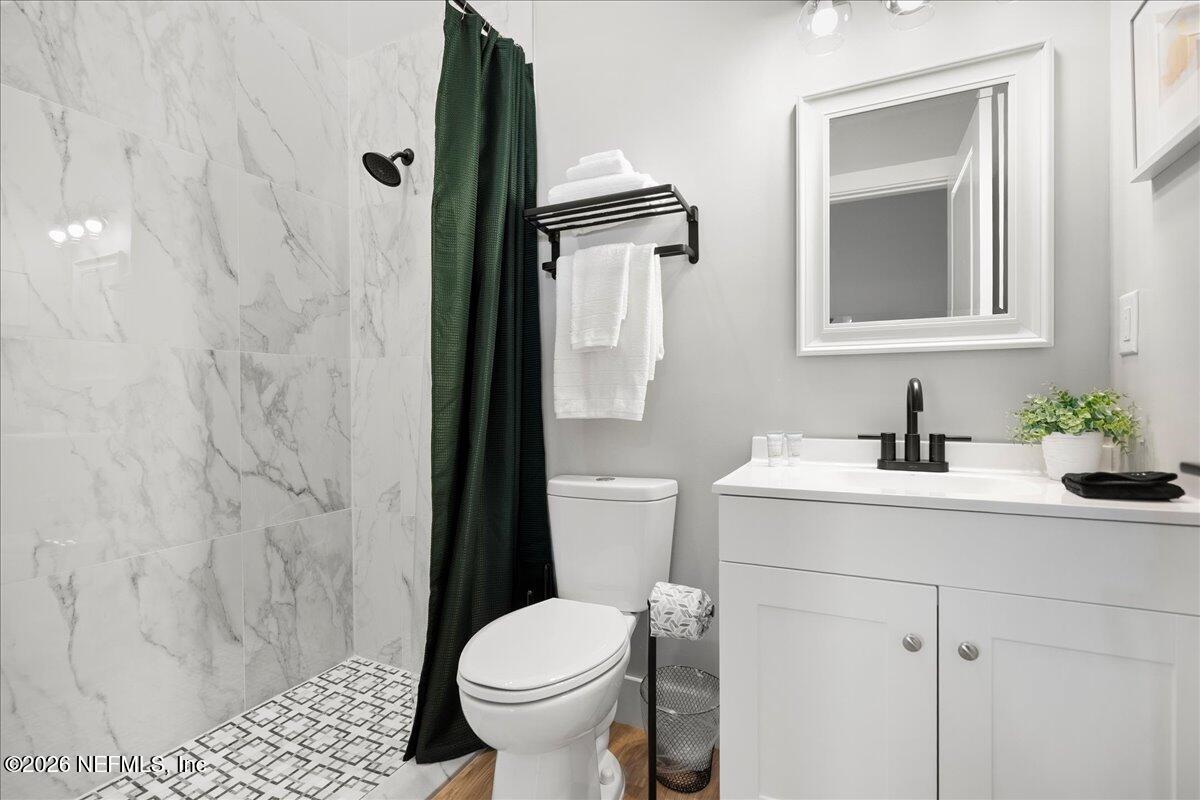 800 9th Street St. Augustine, FL 32084 - Photo 23 of 45 a bathroom with a sink toilet and shower