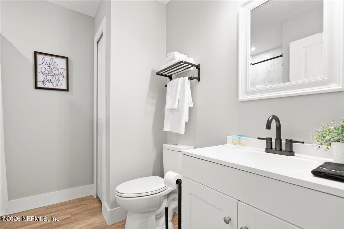 800 9th Street St. Augustine, FL 32084 - Photo 27 of 45 a bathroom with a toilet sink and mirror