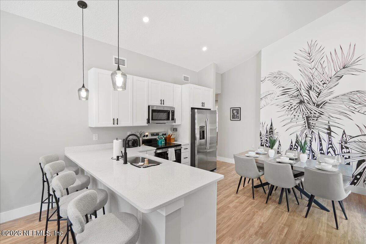 800 9th Street St. Augustine, FL 32084 - Photo 4 of 45 a view of a dining room with furniture and wooden floor