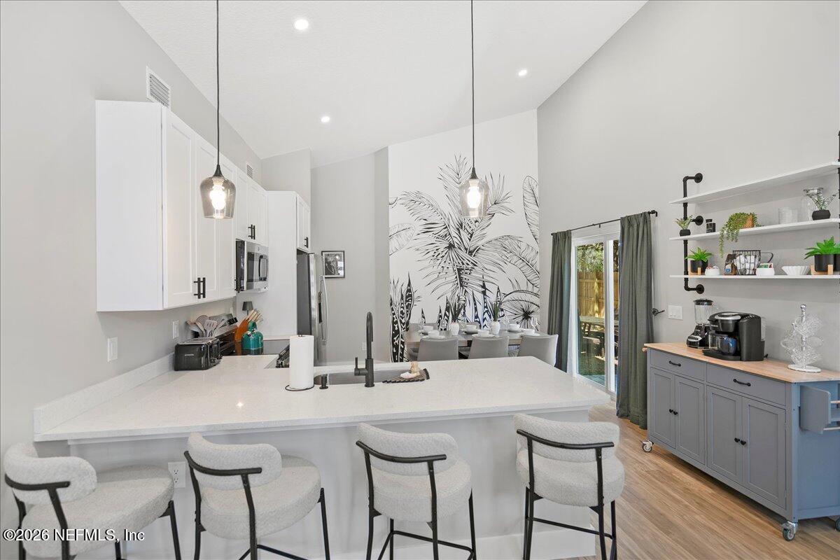 800 9th Street St. Augustine, FL 32084 - Photo 9 of 45 a kitchen with stainless steel appliances kitchen island granite countertop a sink and cabinets
