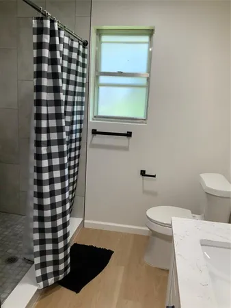 a bathroom with a toilet and a shower