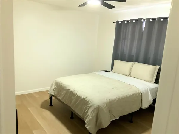 a bedroom with a bed and cabinets