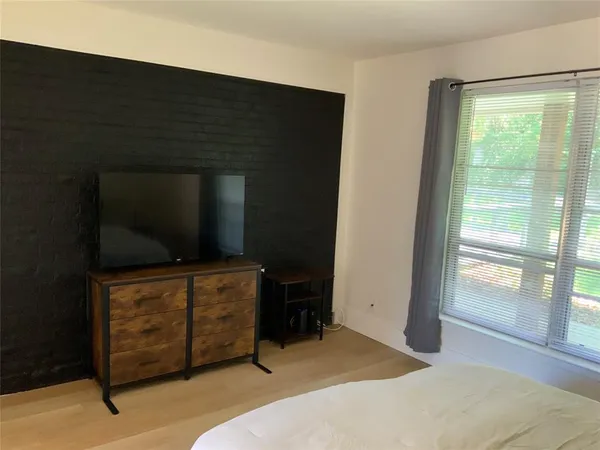 a room with furniture and flat screen tv