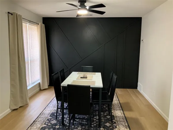 a view of a dining room with furniture and window