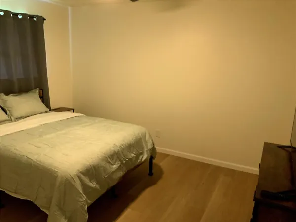 a bed sitting in a bedroom next to a bathroom
