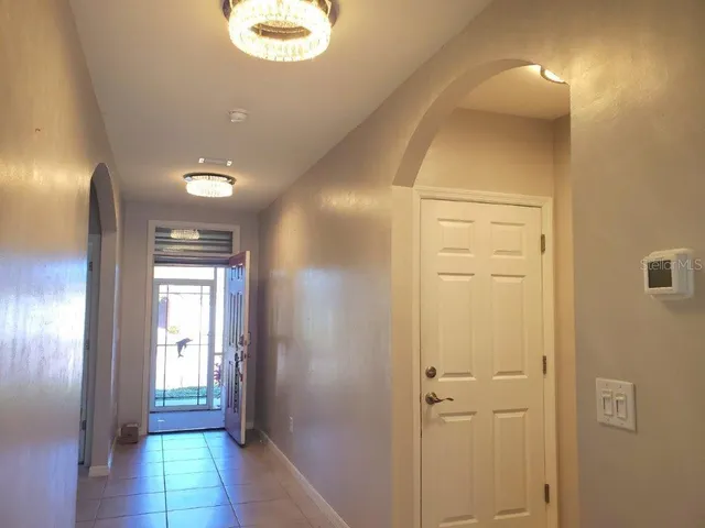 a view of hallway with livingroom and window
